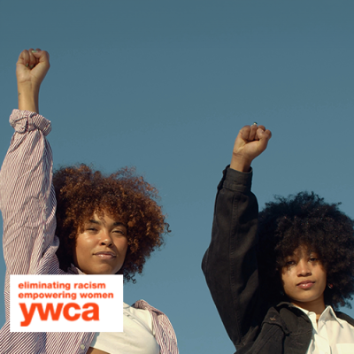 Two African American women raising their fists up in the air