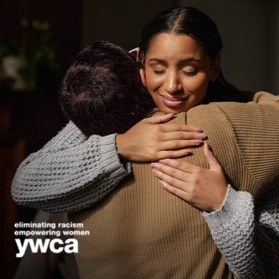 Woman smiling and hugging another person